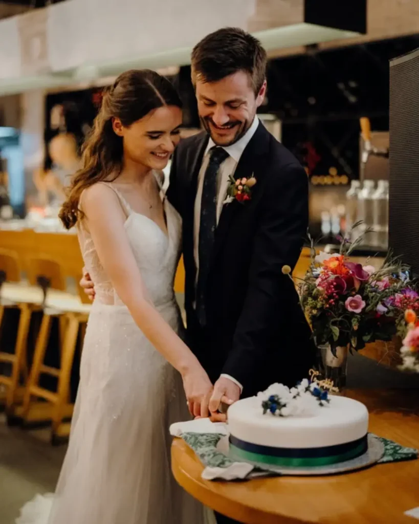 Caroline and James cutting cake